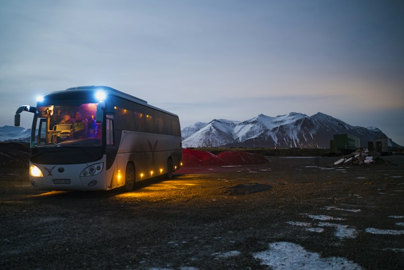 Luxury intercity coach bus with mountains behind